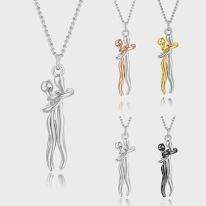 May include: A collection of silver necklaces featuring a pendant of two figures embracing. Additional pendants include rose gold, gold, and black finishes. Each pendant hangs from a delicate chain, showcasing a modern, minimalist design.