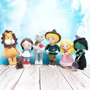 May include: A set of seven crocheted characters from the Wizard of Oz, including Dorothy, the Scarecrow, the Tin Man, the Cowardly Lion, Glinda the Good Witch, the Wicked Witch of the West, and Toto the dog.