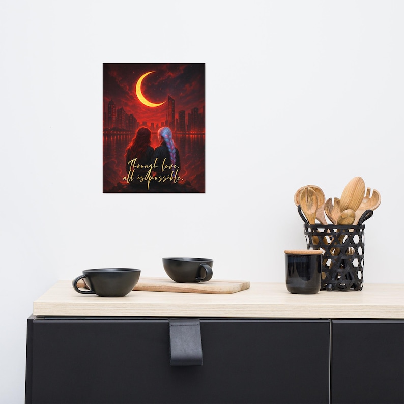May include: A framed art print featuring a romantic scene with two figures silhouetted against a cityscape under a crescent moon. The artwork is in shades of red and gold, with the text "Through love, all is possible."