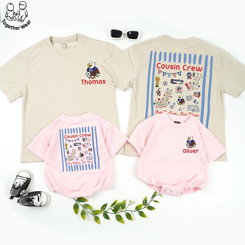 May include: A family matching set of t-shirts and rompers in beige and pink. The beige shirts have an eagle graphic and the name "Thomas". The pink rompers and a beige shirt have "Cousin Crew" text and graphics. The romper has the name "Oliver".