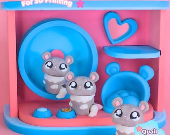 May include: A 3D printed hamster habitat set featuring a pink and blue structure with a circular wheel, a heart-shaped cutout, a platform, and a small bed. Three grey and white hamster figurines are included. Text reads Digital Download For 3D Printing.