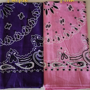 May include: Two square bandanas featuring a traditional paisley pattern in black and white. One bandana is deep purple, and the other is light pink. The text Purple is printed above the purple bandana, and the text Pink is above the pink one.