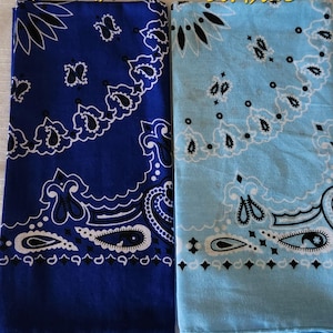 May include: Two square bandanas featuring a traditional paisley pattern in white and black. One bandana is dark blue, and the other is light blue. The text "Dark Blue" is printed above the dark blue bandana, and "Lt. Blue" is above the light blue one.
