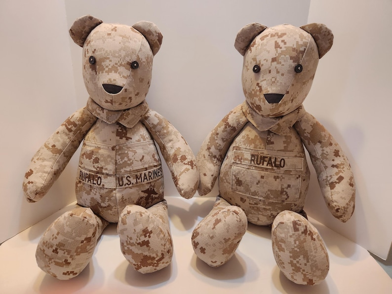 May include: Two camouflage teddy bears, one with the text "U.S. MARINES" and the other with the text "RUFFALO" on their chests.