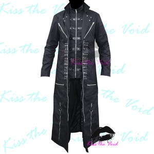 May include: Black long coat featuring multiple zippers, buckles, and silver hardware. The coat has a high collar and a long, flowing design. The text "Kiss the Void" is visible in the background.
