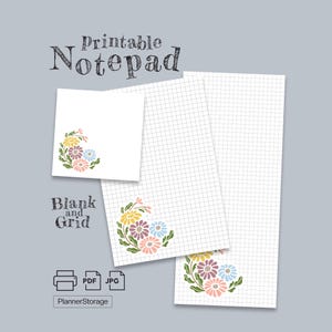 May include: Printable notepad with blank and grid pages. The white paper features a floral design in the corner with yellow, pink, blue, and purple flowers. The text "Printable Notepad" and "Blank and Grid" are also visible.