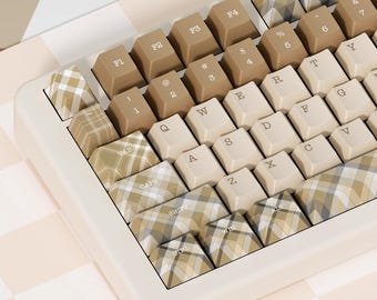 May include: A beige and brown mechanical keyboard with a plaid design on some keys. The keyboard has a white frame and a matching mousepad. The text "仅键帽 不含键盘" is visible.