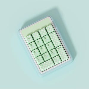 May include: A light green and white number pad with a checkered pattern on the keys. The keys are labeled with numbers, symbols, and the word "Enter".