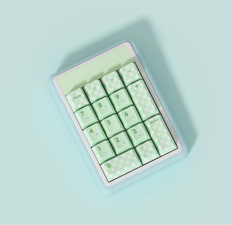 May include: A light green and white number pad with a checkered pattern on the keys. The keys are labeled with numbers, symbols, and the word "Enter".