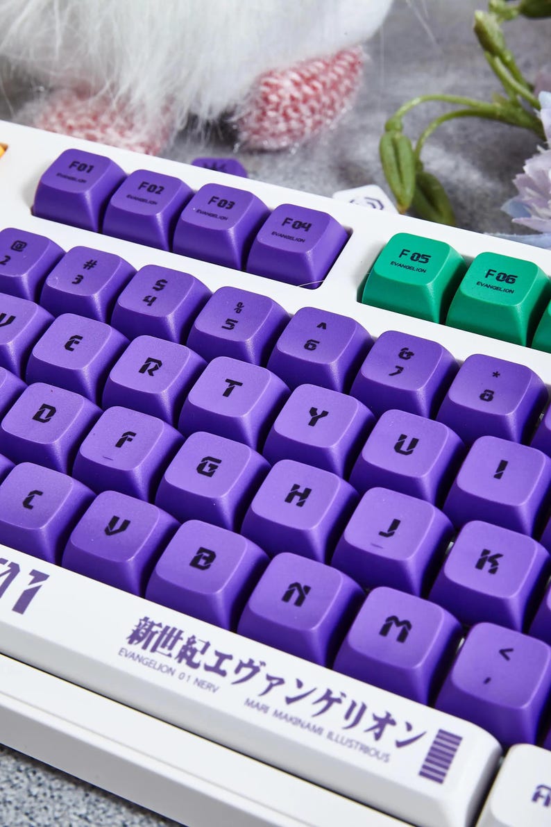 May include: Purple and green keyboard with the text "新世紀エヴァンゲリオン" and "EVANGELION 01 NERV" printed on the space bar.