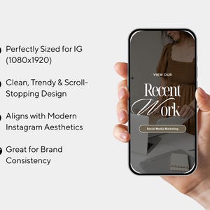 May include: A smartphone displays a social media marketing design with the text "Recent Work." The phone is held in a hand. The design includes a woman in a brown dress and the words "View Our" at the top.