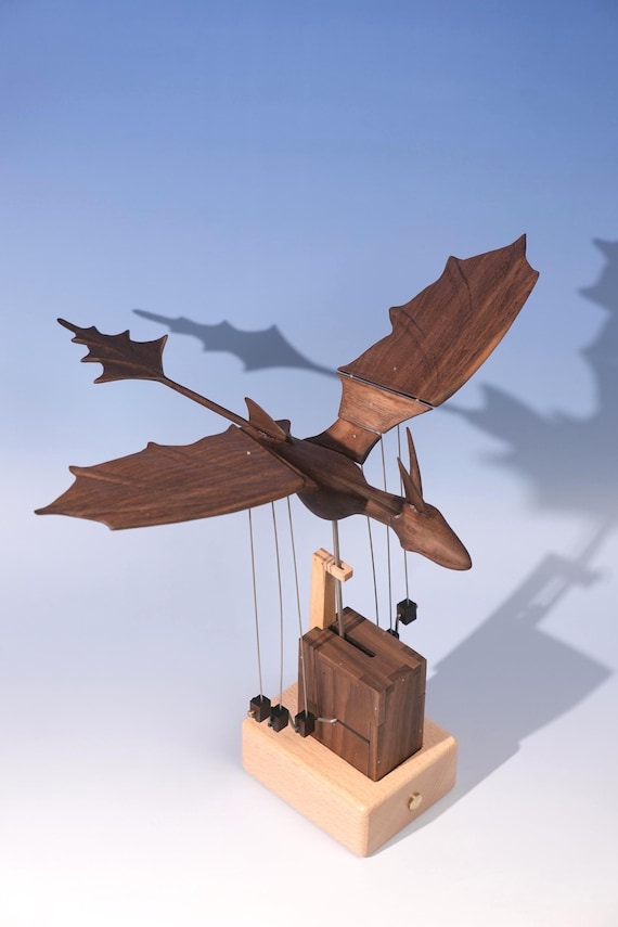 A hand-carved wooden dragon that moves — mechanical scales and motion make this the desk companion every fantasy fan didn't know was possible in wood.