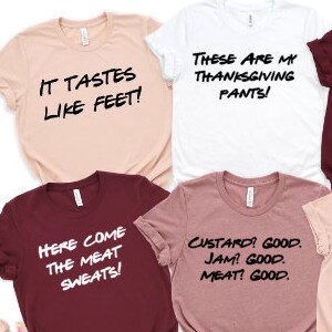 May include: Six different t-shirts with funny Thanksgiving-themed text printed on them. The shirts are in various colors, including pink, white, maroon, and beige.