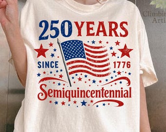 Puede incluir: Camiseta color crema con un diseño patriótico que celebra 250 años desde 1776. El diseño presenta el texto "250 YEARS" en azul y rojo, una bandera estadounidense, estrellas y la palabra "Semiquincentennial".