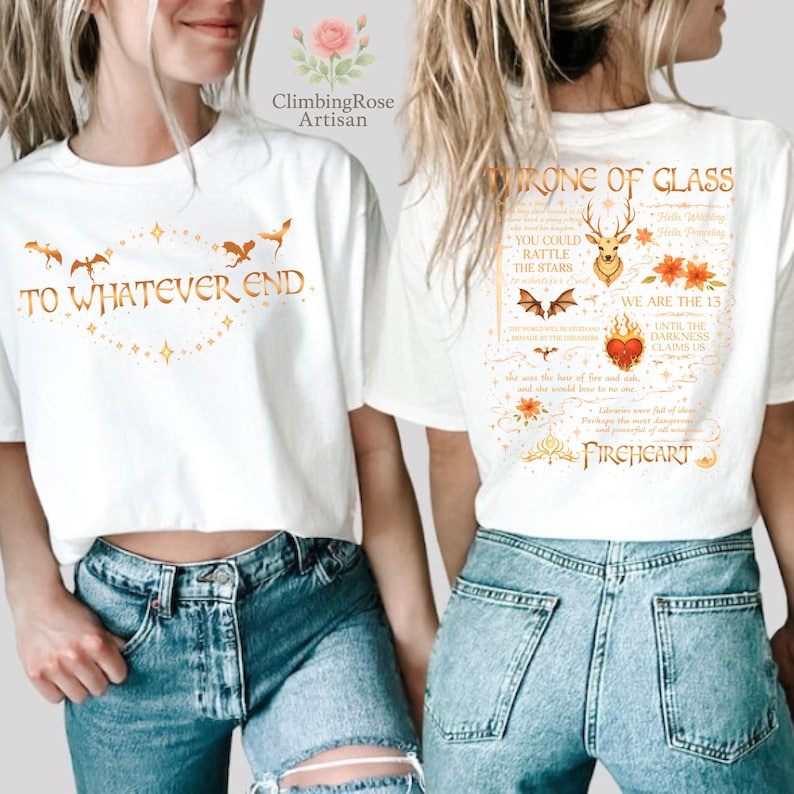 May include: White t-shirts with gold-colored graphics. One shirt reads "TO WHATEVER END" with a decorative border and flying creatures. The other shirt features text that reads "THRONE OF GLASS" and "FIREHEART" with other decorative elements.
