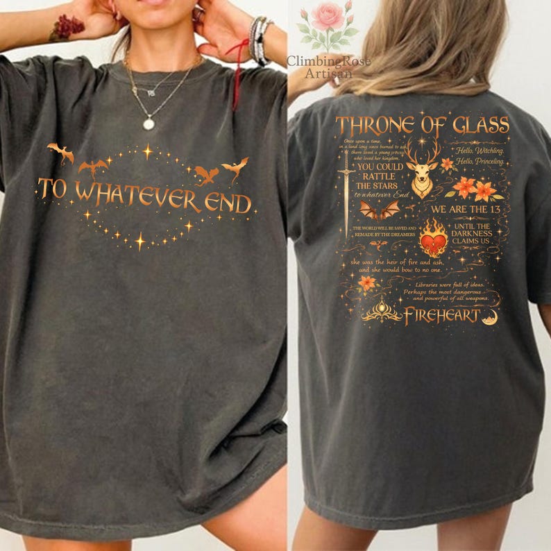 May include: Dark gray t-shirt with the text "TO WHATEVER END" and a design of bats and stars. The back of the shirt features the text "THRONE OF GLASS" with a deer, flowers, and other text. A comfortable, casual tee.