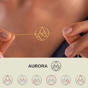 May include: A delicate gold-colored bracelet featuring a circular pendant with an abstract design. The pendant is connected to a fine chain. The word "AURORA" is displayed in a white rectangular box below the bracelet, along with a logo.