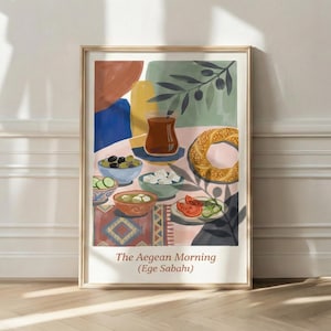 May include: A framed art print titled "The Aegean Morning" featuring a colorful illustration of a breakfast spread. The image includes bowls of olives, cheese, and tomatoes, a sesame bagel, and a glass of tea. The artwork has a warm, inviting aesthetic.