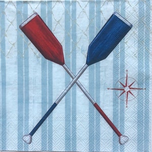 May include: Two wooden oars crossed over each other, one red and one blue, against a light blue and white striped background with a compass rose in the center.