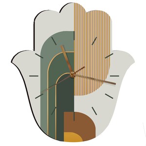 May include: A green, brown, and yellow geometric wall clock in the shape of a hamsa hand. The clock has a white background and gold-colored hands.
