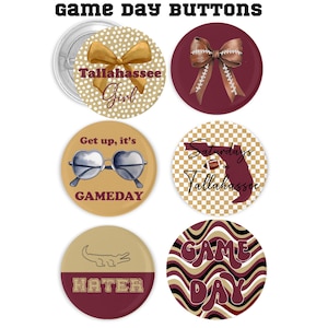 May include: Six round buttons with different designs. The buttons are gold and maroon with white polka dots, checkered patterns, and wavy lines. The text on the buttons includes "Tallahassee Girl", "Get up, it's GAMEDAY", "Saturdays in Tallahassee", "HATER", and "GAME DAY".