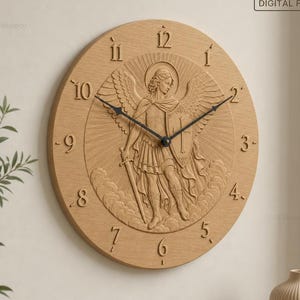 May include: A round light-wood wall clock featuring a relief carving of an angel with wings, a sword, and a shield. The clock face displays the text STL | CNC | 3D Print and DIGITAL FILE, with black clock hands and raised numerals from 1 to 12.