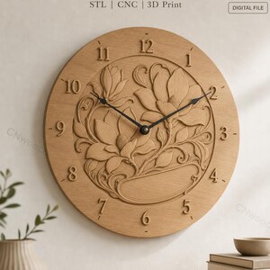 May include: A round wooden wall clock featuring a carved floral relief pattern of magnolia flowers in the center. The clock face displays raised Arabic numerals from 1 to 12 and two black metal hands. Text at the top reads STL | CNC | 3D Print.