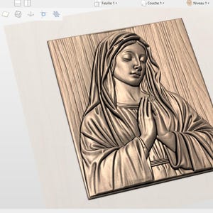 May include: A wooden relief carving of a woman with her hands clasped in prayer. The carving is in a rectangular frame and features detailed textures and shading, creating a three-dimensional effect. The woman is wearing a draped garment.