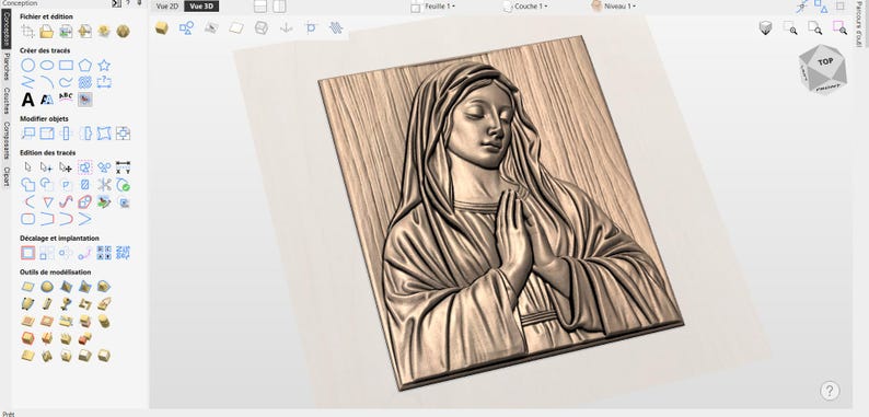 May include: A wooden relief carving of a woman with her hands clasped in prayer. The carving is in a rectangular frame and features detailed textures and shading, creating a three-dimensional effect. The woman is wearing a draped garment.