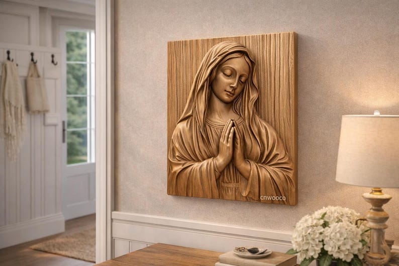 May include: A wooden relief carving of a woman with her hands clasped in prayer. The artwork is mounted on a rectangular wooden panel and is a warm, natural wood tone. The artist's mark, "cnwoooco", is visible on the lower right.