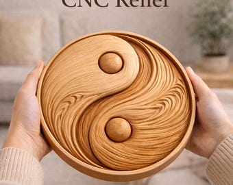 May include: A wooden Yin and Yang symbol with a carved relief design. The symbol is held by hands and features a light brown color with the text "CNC Relief" at the top. The design has two circular wooden knobs.
