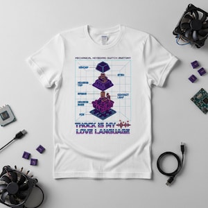 May include: White t-shirt with a diagram of a mechanical keyboard switch in purple and blue, with labels. The text "THOCK IS MY LOVE LANGUAGE" is at the bottom. The shirt is a Gildan brand.