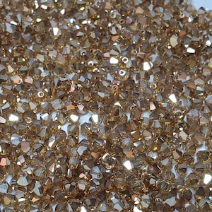 4mm Preciosa Czech Crystal Golden Flare 2X Faceted Bicone - Bag of 50