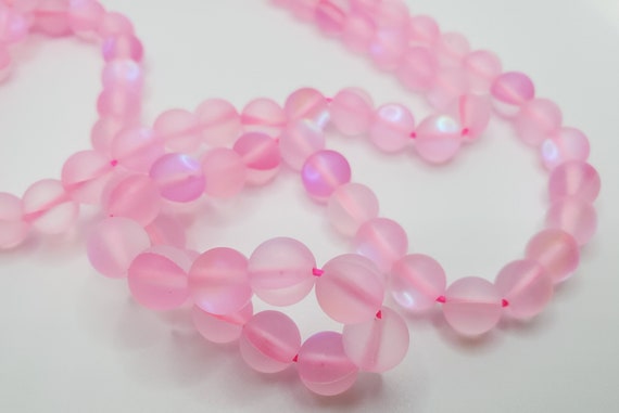 Bead, iridescent glass, translucent matte pink, 8mm round. Sold