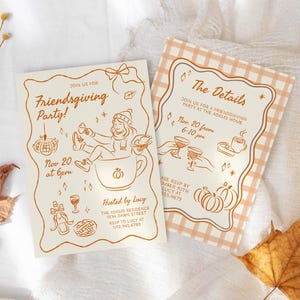 May include: Two cream-colored Friendsgiving party invitations with orange illustrations and text. One features a person in a mug, the other has a checkered border. Dried leaves and flowers are arranged around the invitations.