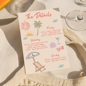 May include: A cream-colored card with the text "The Details" in red script, listing a weekend itinerary with illustrations of a disco ball, palm tree, and beach chair. The card is next to a glass and a woven bag.