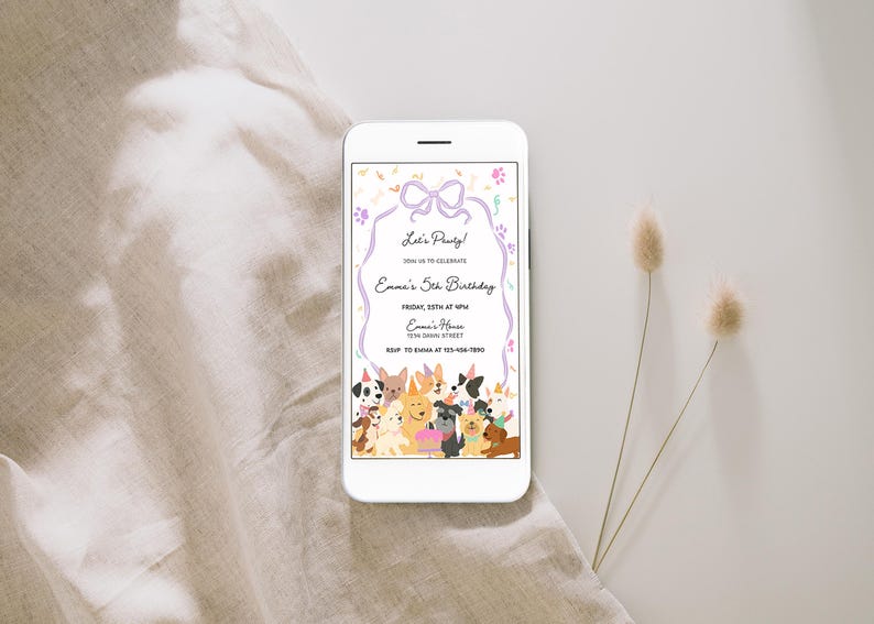 May include: A white smartphone displays a birthday party invitation with a dog theme. The invitation features a purple bow, paw prints, and a border with the text "Let's Party!" and "Emma's 5th Birthday". A variety of cartoon dogs are at the bottom.
