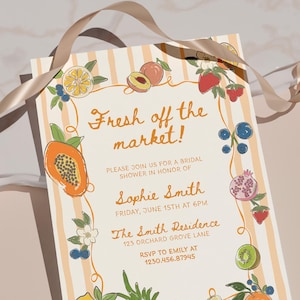 May include: A rectangular bridal shower invitation card with a cream and orange striped background, featuring illustrations of various fruits like papaya, berries, and citrus. The text reads: Fresh off the market! Please join us for a bridal shower in honor of Sophie Smith, Friday, June 15th at 6pm, The Smith Residence, 123 Orchard Grove Lane, RSVP to Emily at 1230.456.87945.