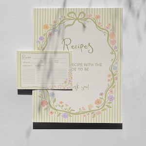 Peut inclure: Une carte de recette et un grand porte-recette avec un motif floral. Le porte-recette porte l'inscription "Recettes" en écriture manuscrite et une bordure florale. La carte de recette comporte des espaces pour les ingrédients et les instructions.
