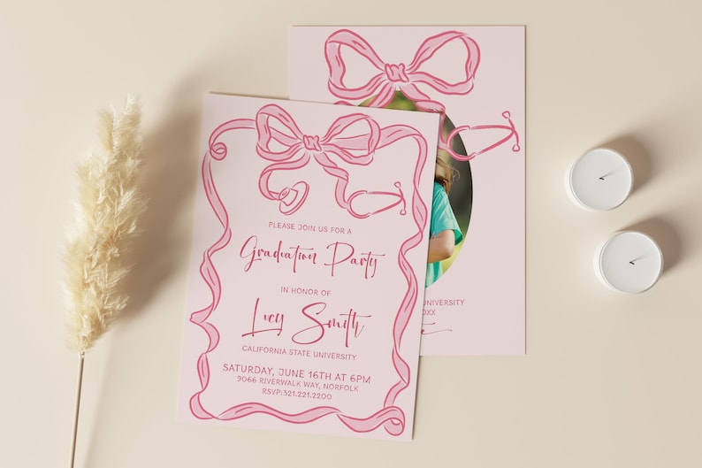 May include: Pink graduation party invitation with a pink ribbon design and a photo of a graduate. The invitation says "Please join us for a Graduation Party in honor of Lucy Smith, California State University, Saturday, June 16th at 6pm, 9044 Riverwalk Way, Norfolk, RSVP 521.221.2200".