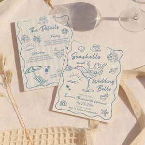 May include: Two light blue invitation cards with beach-themed illustrations and text. One card says "The Details" and lists a weekend itinerary. The other says "Seashells and Wedding Bells" and invites guests to Emma's Bachelorette Weekend.