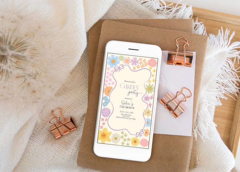 May include: A digital invitation on a smartphone screen with a floral border and the text "Garden Party" in honor of Sofia & David. The invitation includes the date, time, and location of the event.