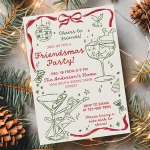 May include: A cream-colored Friendsmas Party invitation with red and green illustrations. The invitation includes text that reads "Cheers to friends!" and "Please bring a side dish to share!" The invitation is surrounded by pine needles, pine cones, and string lights.