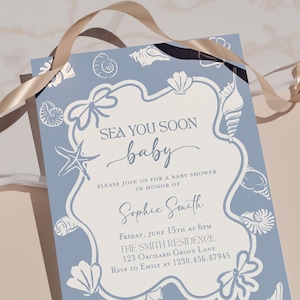 May include: A baby shower invitation with a light blue background and white seashell illustrations. The invitation reads "SEA YOU SOON baby" and includes details for the event, such as the date, time, location, and RSVP information.
