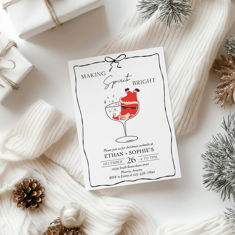 May include: A white invitation card with a black border and the words "MAKING Spirit BRIGHT". The card features a Santa Claus illustration in a cocktail glass. The invitation is for Christmas cocktails at Ethan + Sophie's on December 26.