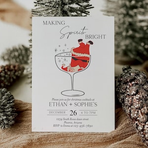 May include: A white invitation card with the text "MAKING Spirit BRIGHT" and a Santa Claus illustration in a cocktail glass. The card also includes event details for Ethan and Sophie's Christmas cocktails on December 26th.