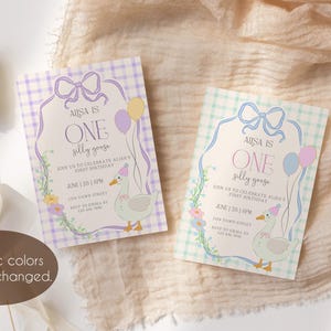 May include: Two printable invitations for a first birthday party. The invitations feature a light blue and white gingham pattern with a purple bow and a yellow and pink balloon. The text on the invitations reads "Aisa is One silly goose".