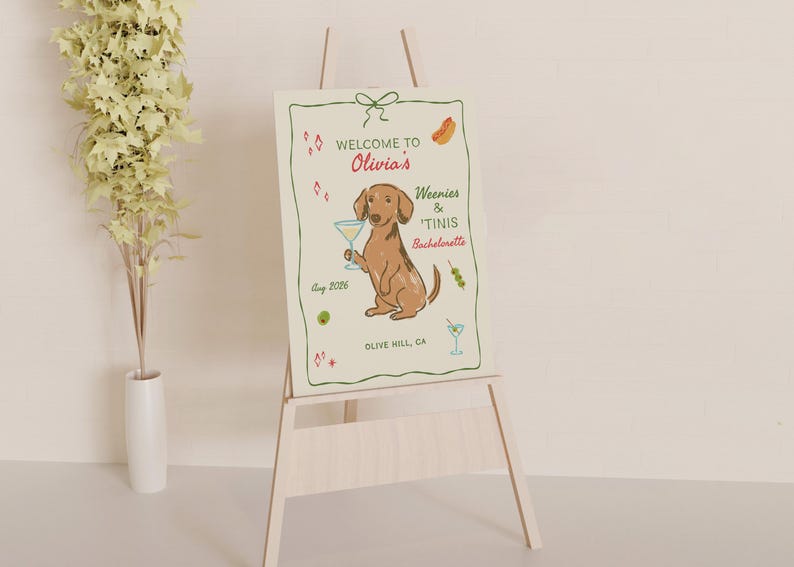 May include: A rectangular sign featuring a brown dachshund holding a martini glass, with text reading Welcome to Olivia's Weenies & 'Tinis Bachelorette, Aug 2026, Olive Hill, CA, surrounded by illustrations of hot dogs, olives, and martini glasses.
