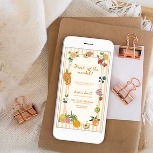 May include: A white smartphone displaying a digital invitation with a light orange striped background, decorated with colorful illustrations of various fruits and flowers, featuring the text Fresh off the market, Sophie Smith, and event details.