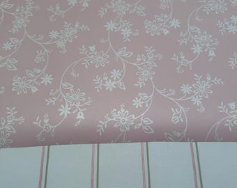 May include: Pink wallpaper with a white floral pattern. The bottom half of the image shows a white wallpaper with pink and green vertical stripes.